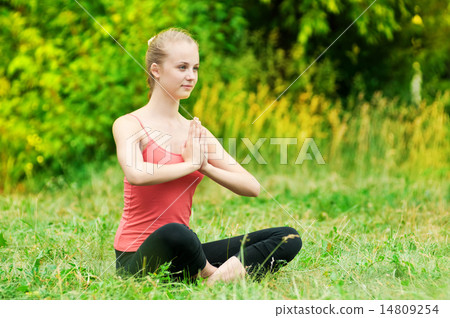 Young woman doing stretching exercise Young woman doing stretching exercise 14809254