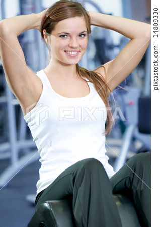 Beautiful sport woman doing press exercise 14809330