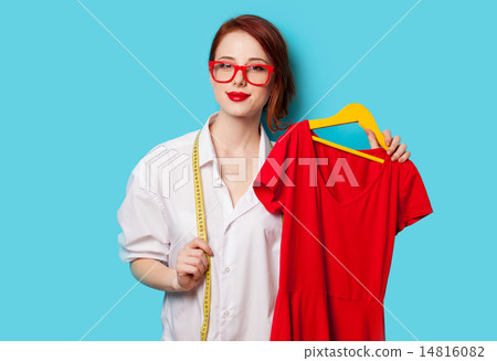 Young redhead designer with red dress Young redhead designer with red dress 14816082