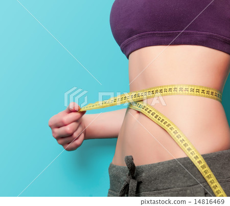 Woman showing her abs with metric 14816469