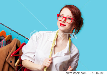 Young redhead designer with metric and clothes 14816486