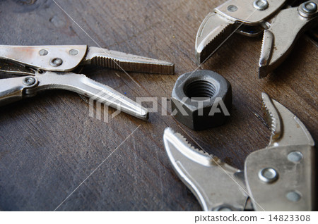 close up locking pliers on wooden background, Hand 14823308