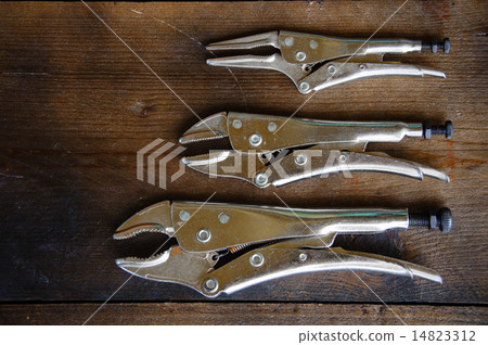 close up locking pliers on wooden background, Hand close up locking pliers on wooden background, Hand 14823312