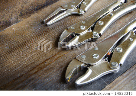 close up locking pliers on wooden background, Hand close up locking pliers on wooden background, Hand 14823315