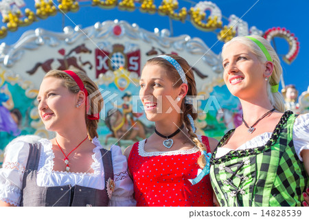 Friends visiting Bavarian fair having fun 14828539