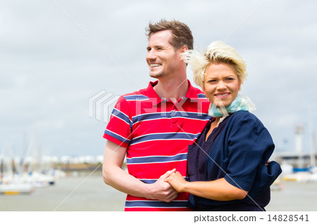 Couple hugging at marina pier 14828541