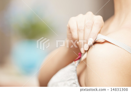 Woman undressing brassiere 14831308