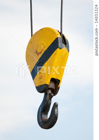 Crane hook hanging on steel ropes over cloudy sky 14831324