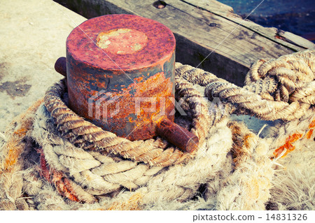 Old rusted mooring bollard with naval ropes 14831326