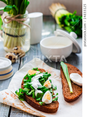 bread with wild garlic, sour cream and quail eggs 14833125