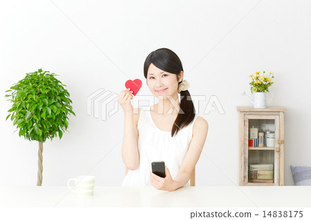 A woman with a smartphone and a heart 14838175