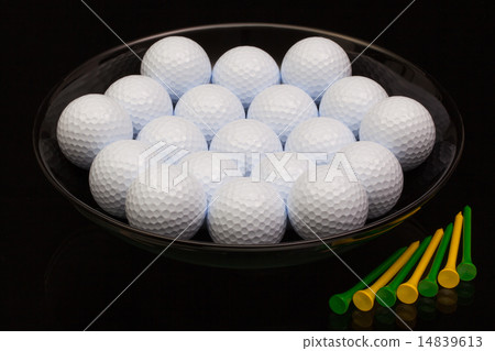 Black ceramic bowl full of golf balls 14839613