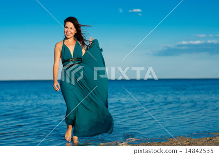 Young woman at the beach in beautiful dress 14842535