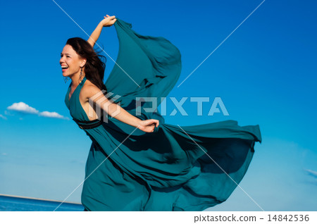 Young woman at the beach in beautiful dress 14842536