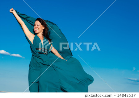 Young woman at the beach in beautiful dress Young woman at the beach in beautiful dress 14842537