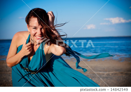 Young woman at the beach in beautiful dress 14842549