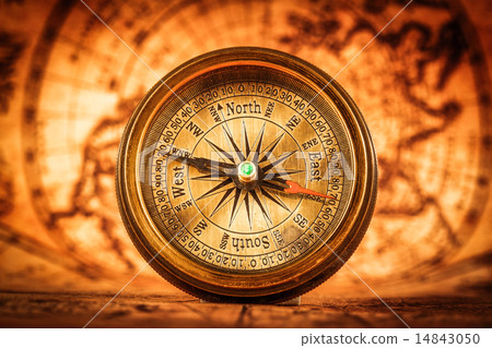 Vintage compass lies on an ancient world map. 14843050