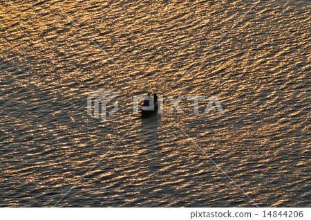 A glowing sea and a boat 14844206