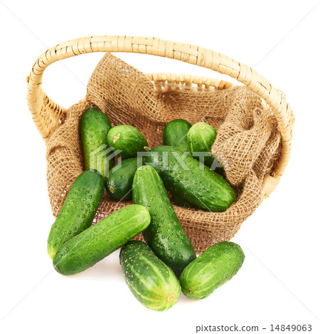 Wicker basket full of cucumbers isolated 14849063