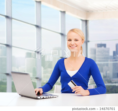 happy businesswoman with laptop and credit card happy businesswoman with laptop and credit card 14870701