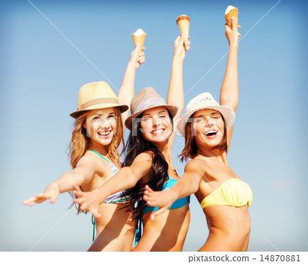 girls in bikinis with ice cream on the beach girls in bikinis with ice cream on the beach 14870881