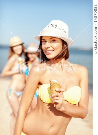 girl in bikini eating ice cream on the beach girl in bikini eating ice cream on the beach 14870888