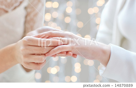 close up of lesbian couple hands with wedding ring close up of lesbian couple hands with wedding ring 14870889