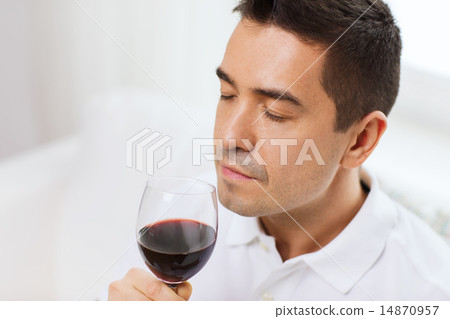 happy man drinking red wine from glass at home 14870957