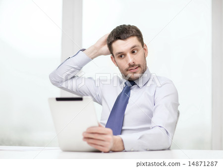stressed businessman with tablet pc and documents 14871287