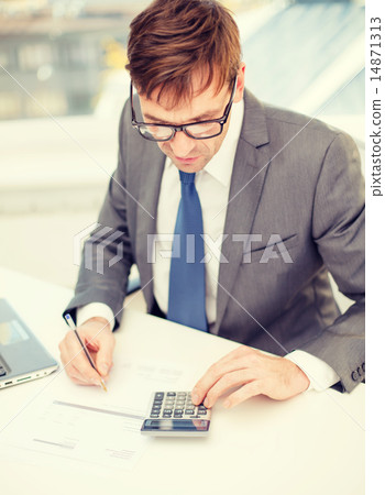 businessman with computer, papers and calculator businessman with computer, papers and calculator 14871313