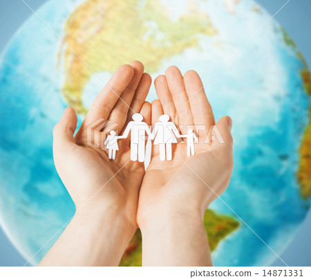 human hands holding paper family over earth globe 14871331