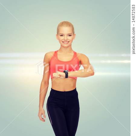 smiling woman with heart rate monitor on hand 14872583