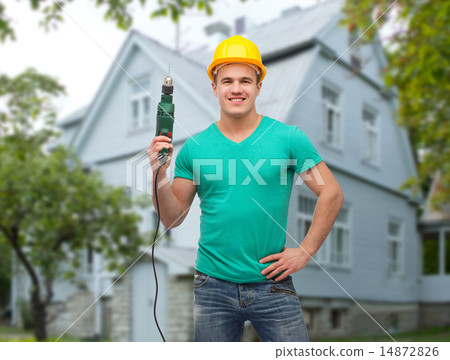 happy male builder in helmet with electric drill 14872826
