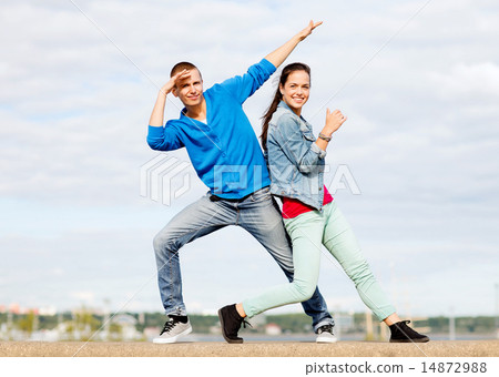 couple of teenagers dancing outside 14872988