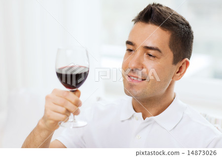 happy man drinking red wine from glass at home 14873026