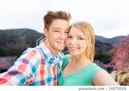 smiling couple taking selfie over asian landscape smiling couple taking selfie over asian landscape 14873029