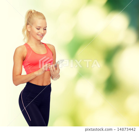 smiling sporty woman with smartphone smiling sporty woman with smartphone 14873442