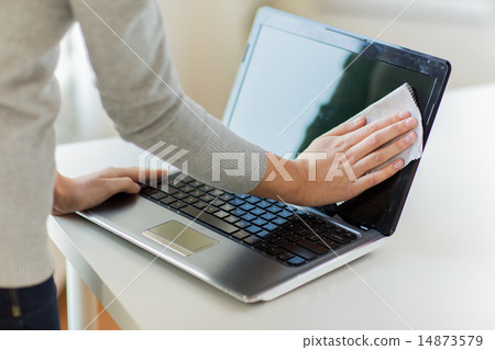 close up of woman hands cleaning laptop screen 14873579
