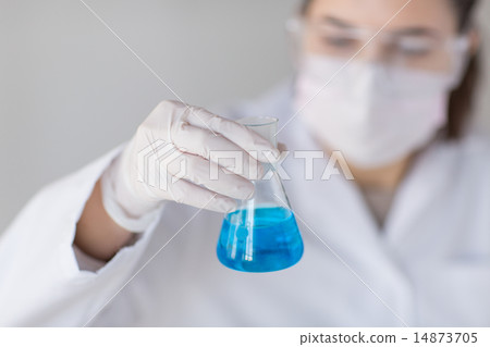 close up of woman with flask making test in lab 14873705