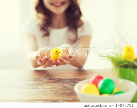 close up of girl holding yellow chiken toy 14873791