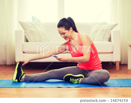 smiling teenage girl streching on floor at home smiling teenage girl streching on floor at home 14874259