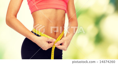 close up of female hands measuring waist close up of female hands measuring waist 14874260