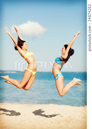 girls jumping on the beach 14874262