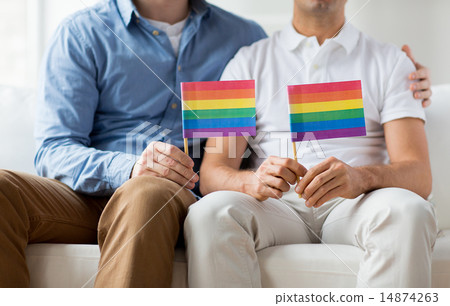 close up of male gay couple holding rainbow flags close up of male gay couple holding rainbow flags 14874263