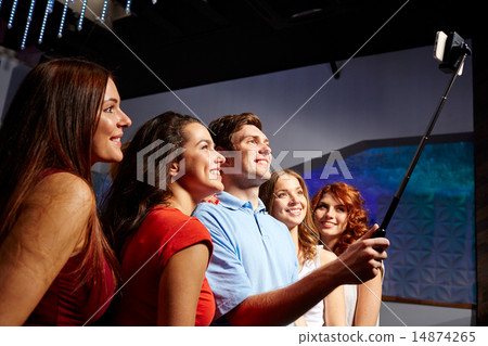 friends with smartphone taking selfie in club friends with smartphone taking selfie in club 14874265