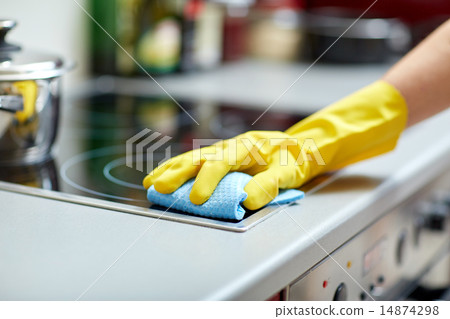 close up of woman cleaning cooker at home kitchen 14874298