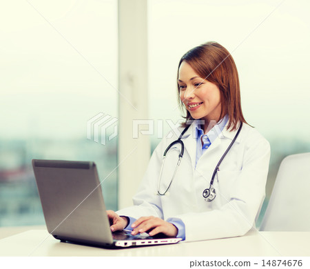 busy doctor with laptop computer 14874676