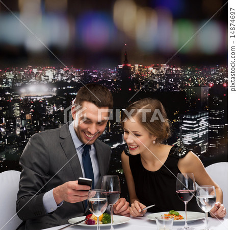 smiling couple eating main course at restaurant 14874697