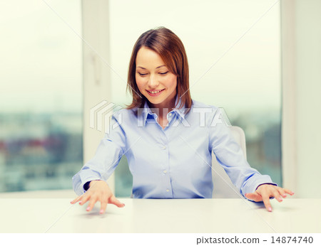 smiling woman pointing to something imaginary 14874740
