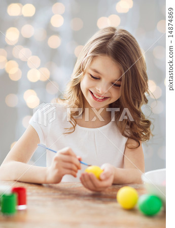 close up of girl with brush coloring easter eggs close up of girl with brush coloring easter eggs 14874869